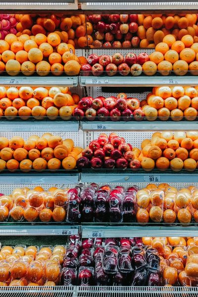 Colorful variety of fresh fruits neatly arranged on supermarket shelves, showcasing abundance and freshness.